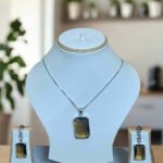 Elegant Pendant Set featuring Smoky Yellow stone and CZ, displayed with matching earrings on a white stand.