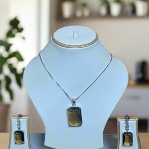 Elegant Pendant Set featuring Smoky Yellow stone and CZ, displayed with matching earrings on a white stand.