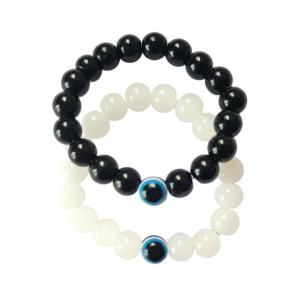 Two beaded bracelets, one black and one white with blue evil eye beads, on a light gray background.