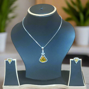 Aqua yellow CZ studded pendant set displayed on a black jewelry stand, featuring a silver-plated chain and matching earrings by Garimas.