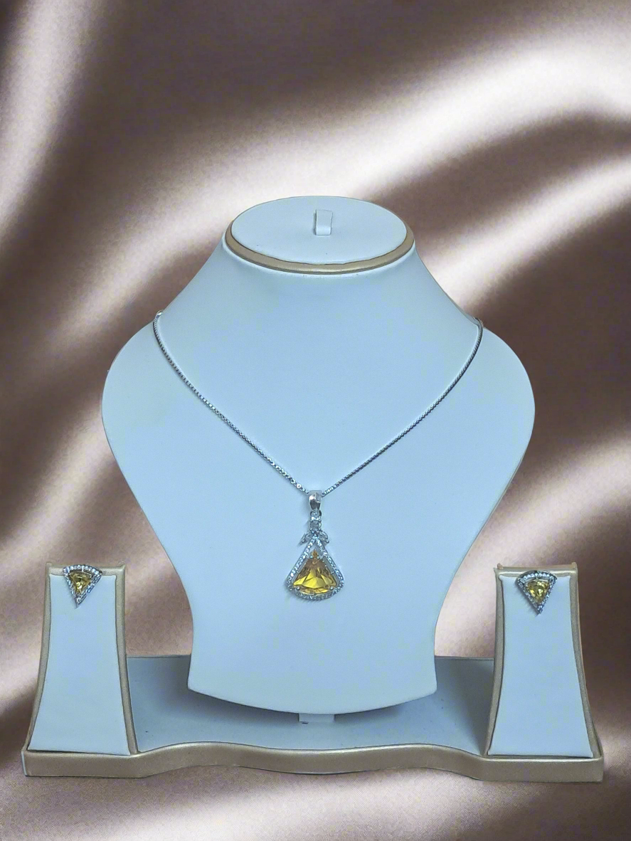 background-editor_output_73f3f281-13a4-43dc-9aaf-842da36bf92f Exquisite Aqua Yellow CZ studded pendant set on display with silver plated chain by Garimas against elegant backdrop.