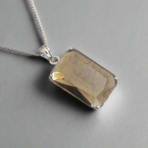 Smoky yellow pendant on a silver chain, part of Garimas elegant jewelry set, perfect for any occasion.